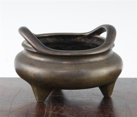 A Chinese bronze two handled tripod censer, Ding, Xuande six character mark, 18th / 19th century, 13cm